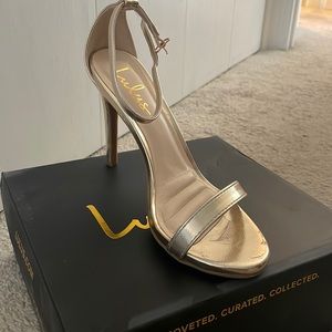 Gold strappy high heels.